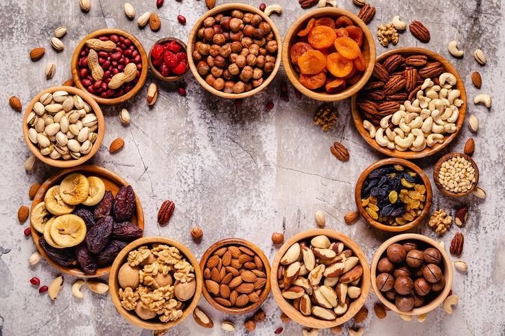 various nuts and dried fruits in woo featuring above, almond, and apricot